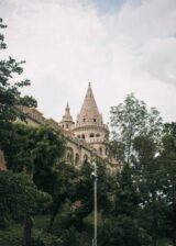 building in the Fisherman's bastion, surrounded by trees and greenery