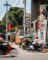 busy road in yogyakarta with bikes and tuktuk