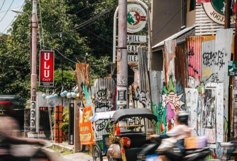 busy road in yogyakarta with bikes and tuktuk